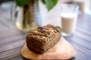 Vegan banana bread with green buckwheat and glass oat milk.