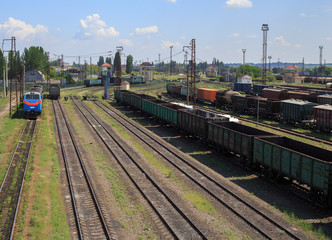 Fototapeta na wymiar Freight trains on city cargo terminal. Railways in train parking. Arain arrived at the station. Cargo train platform with freight train container at depot in port use for export logistics background.