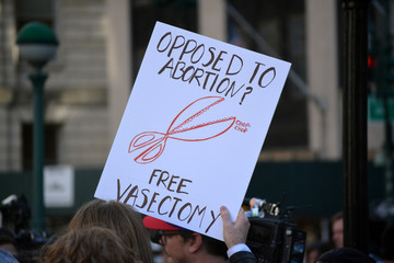 People holding signs in New York City protesting abortion bans that have swept across parts of the...