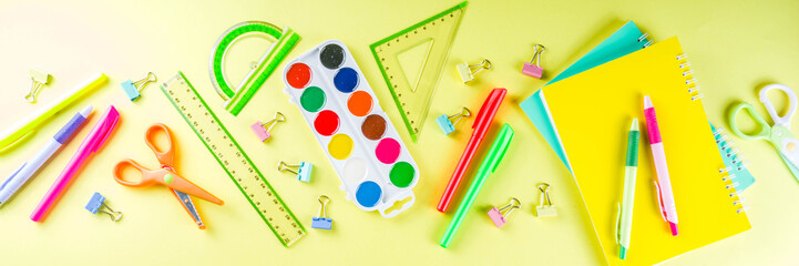 Colorful back to school background. Bright background with school supplies, stationery, pens, pencils, rulers, notebooks, copy space for text, whiteboard for notes, flat lay top view