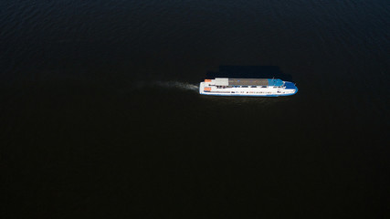 Fototapeta premium Large transport ship sailing on the river, top view