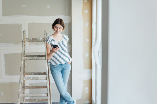 Young woman doing renovations at home