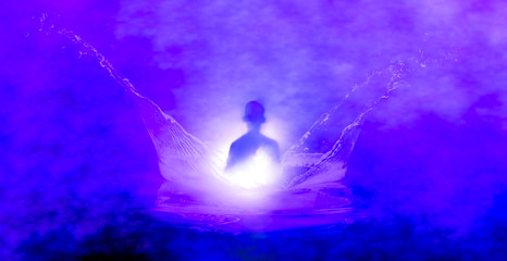 Purple image of a meditating silhouette in splash of water