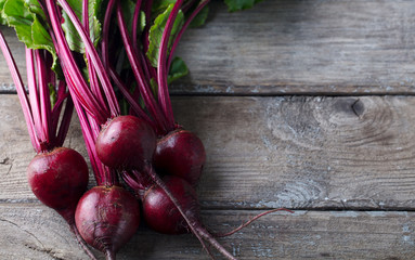 Beet, beetroot bunch on grey wooden background. Top view. Copy space.