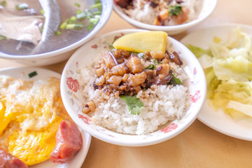Braised pork over rice - Taiwan famous traditional street food delicacy. Soy-stewed pork on rice. Travel design concept. Top view,copy space,close up