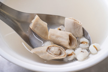 Four tonics soup, four ingredients herb flavor soup. Taiwanese delicious street food delicacy with Job's tears, pork intestines, close up, copy space