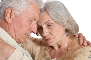 Portrait of sad senior couple on white background