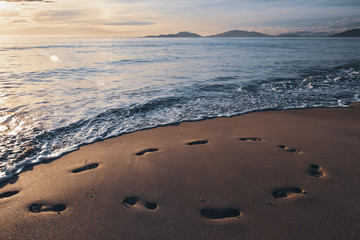 footprints in the sand from the feet of a lost person. no way out of the situation. return to the be