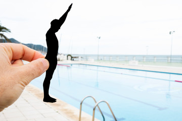 silhouette of a man throwing himself into a pool