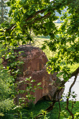 natural sand stone cliffs on the shore of the river in forest