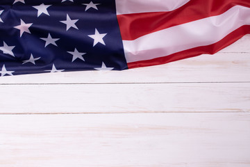 American flag on white wooden background for Memorial Day or 4th of July, or Independence day with copy space.