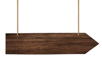 Simple wooden arrow signpost made of dark wood hanging on ropes
