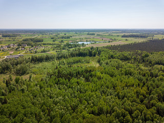 Obraz premium aerial view of countryside fields and forests in green summer day