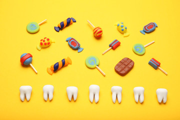 Teeth with sweet candies. Tooth caries in children's, dental healthcare.