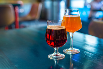 glasses of craft beer are on the table in the bar. lager and stout