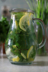 Refreshing lemonade with mint and lemon for a hot summer day in a bottle