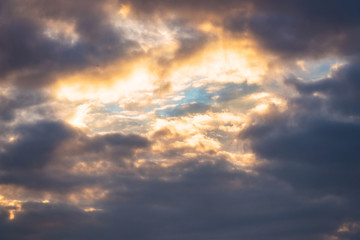 Blue sky among dark clouds