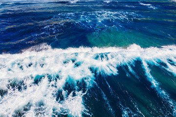 Blue water texture with wave crest. Concept ocean background