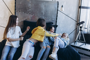 Beautiful cute young stylish girls playing together smiling, professional kids models posing in studio. Cover girl, modeling, beauty, fashion concept