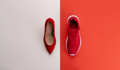 A studio shot of running vs high heel shoe on color background. Flat lay.