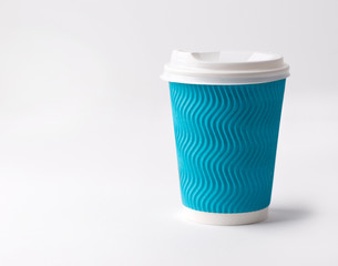 Take-out coffee in paper cup on a white background.