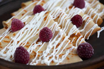 Pancakes with sour cream and raspberry. Delicious home breakfast. 