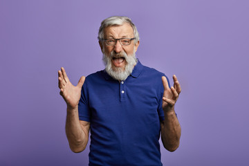 scared frightened man with raised arms looking at the camera and screaming. man is afraid of...