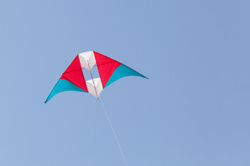 colorful kite flying in a beautiful blue sky