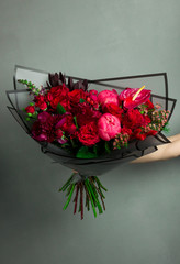 a rich bouquet of flowers from rare plants, the work of a florist, in the hands of