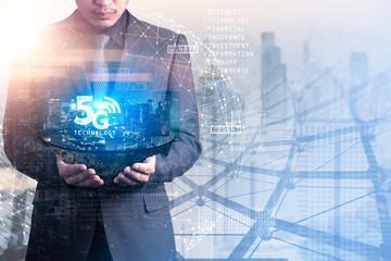 the double exposure image of the businessman hold the cityscape island overlay with 5G hologram and cotyscape image. the concept of future,5g, communication, business and internet of things.