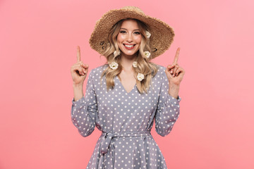 Beautiful young blonde woman wearing summer hat