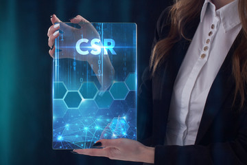 The concept of business, technology, the Internet and the network. A young entrepreneur working on a virtual screen of the future and sees the inscription: CSR
