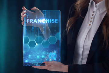 The concept of business, technology, the Internet and the network. A young entrepreneur working on a virtual screen of the future and sees the inscription: Franchise