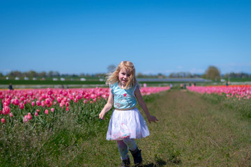 Little Girl Happy in a Tulip Field