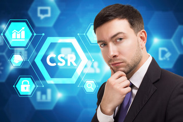 The concept of business, technology, the Internet and the network. A young entrepreneur working on a virtual screen of the future and sees the inscription: CSR