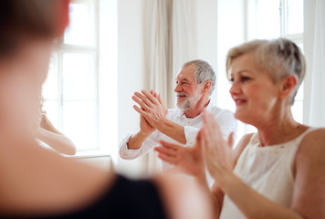 Group of senior people in dancing class with dance teacher.