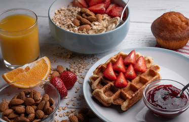 Delicious oatmeal or granola on breakfast. Belgian waffle. Morning sweet food. Strawberry lunch. Homemade cake