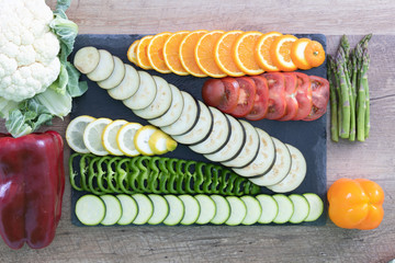 Collage of several vegetables arranged on a wooden table