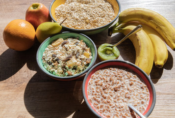 Top view of milk in bowl with cereal, fresh kiwi and banana