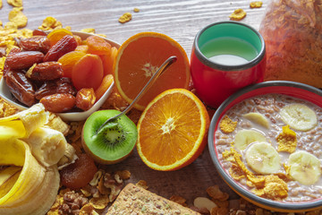 Fototapeta na wymiar Healthy breakfast - milk, cereals, banana, granola, kiwi