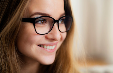 Fototapeta premium A close-up portrait of young female student standing indoors.