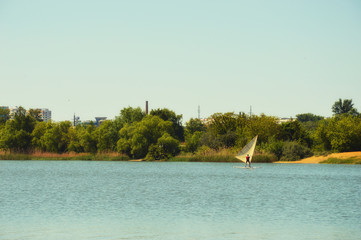 Fototapeta na wymiar blue lake with green bushes and blue sky