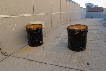 Old rusty and dented metal buckets, on a New York City rooftop, Bronx, NY