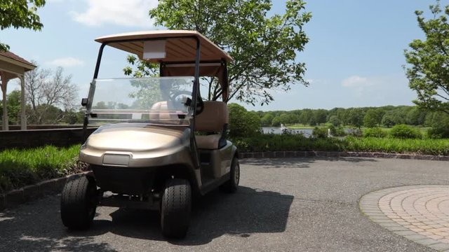 Slow motion move into golf cart on golf course