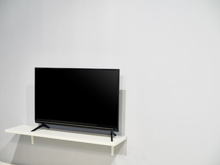 A television set with a big blank wall