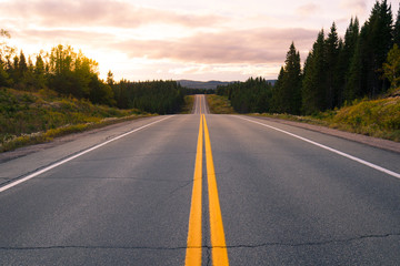 Naklejka premium Straight road at sunset in Canada
