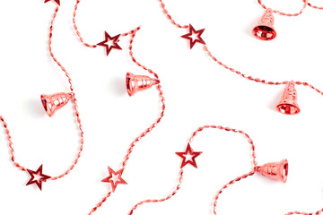 New Year's concept. red garland of beads, stars and bells on a white background. flat lay, top view