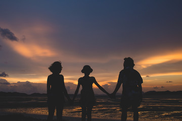 family on the beach at sunset