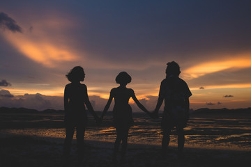 Fototapeta na wymiar family on the beach at sunset