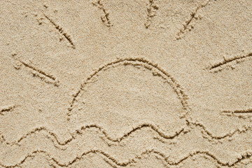 sun and waves written on sand
